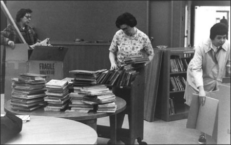 Librarians organizing and shelving books. 