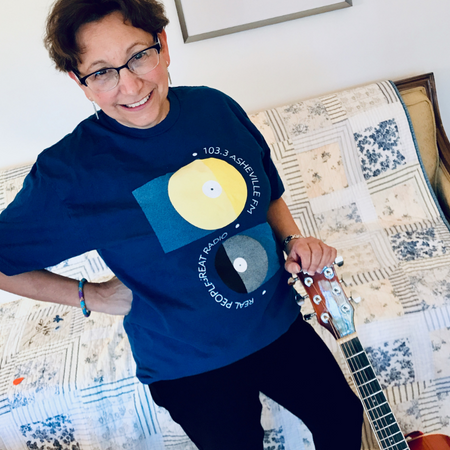Amy wearing a blue shirt and holding a guitar