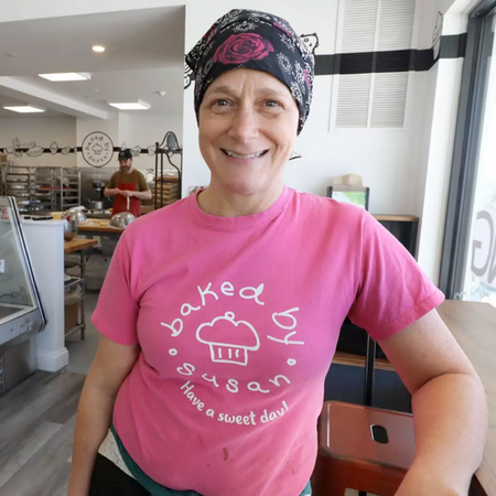 Smiling baker in a pink t-shirt