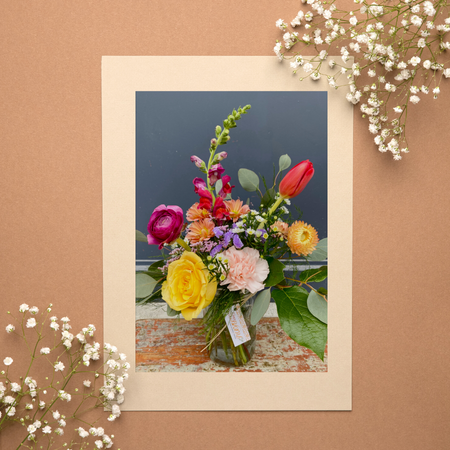 Flowers in a mason jar on a copper background
