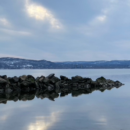 Photo of the Hudson River with rock outcropping