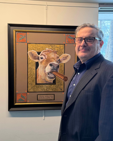 John Cote in front of a painting