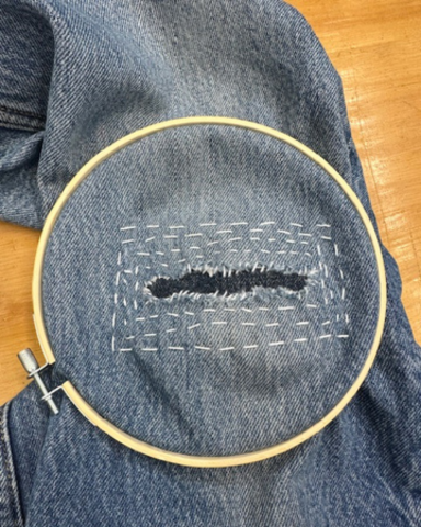 Jeans with a mended patch