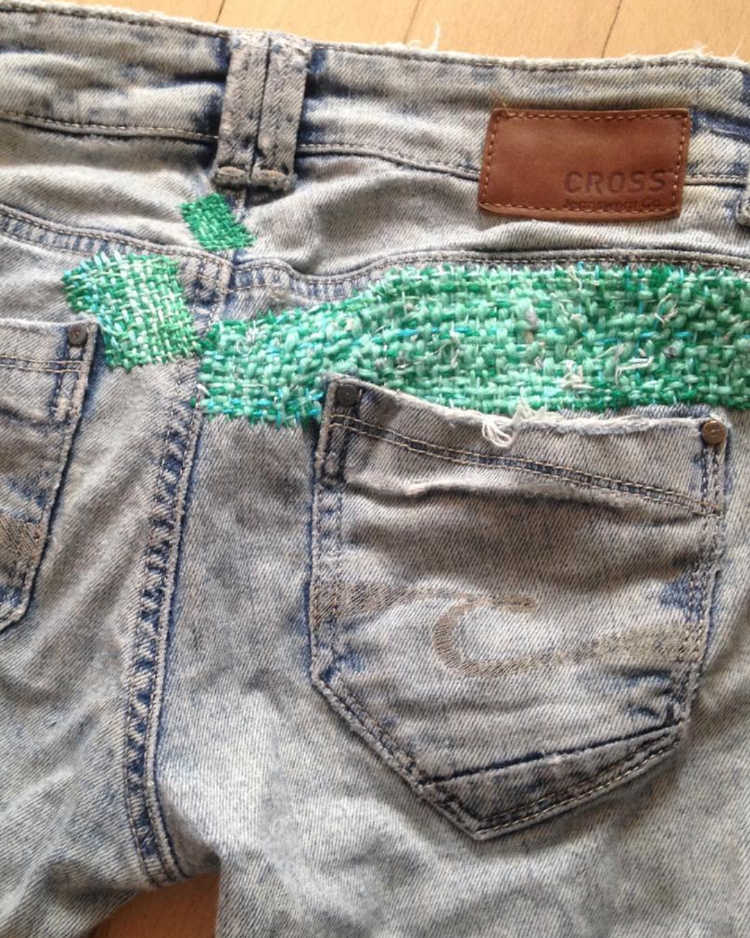 Jeans with a green mended patch